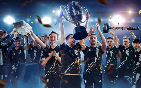 G2 Esports team celebrates victory, lifting a trophy amidst confetti and cheers, capturing the excitement of competitive gaming in this vibrant HD desktop wallpaper.