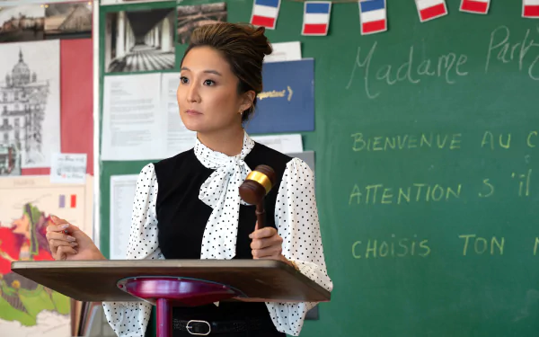 HD desktop wallpaper featuring a character from the movie Mean Girls (2024) standing in a classroom.