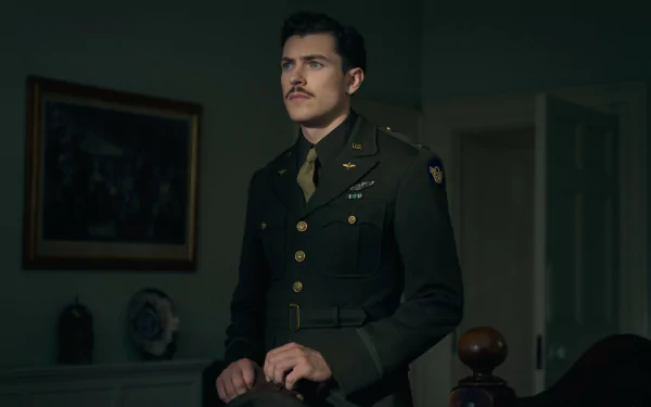 HD wallpaper of an intense scene from the TV show Masters of the Air featuring a military officer in uniform standing thoughtfully in a dimly lit room.