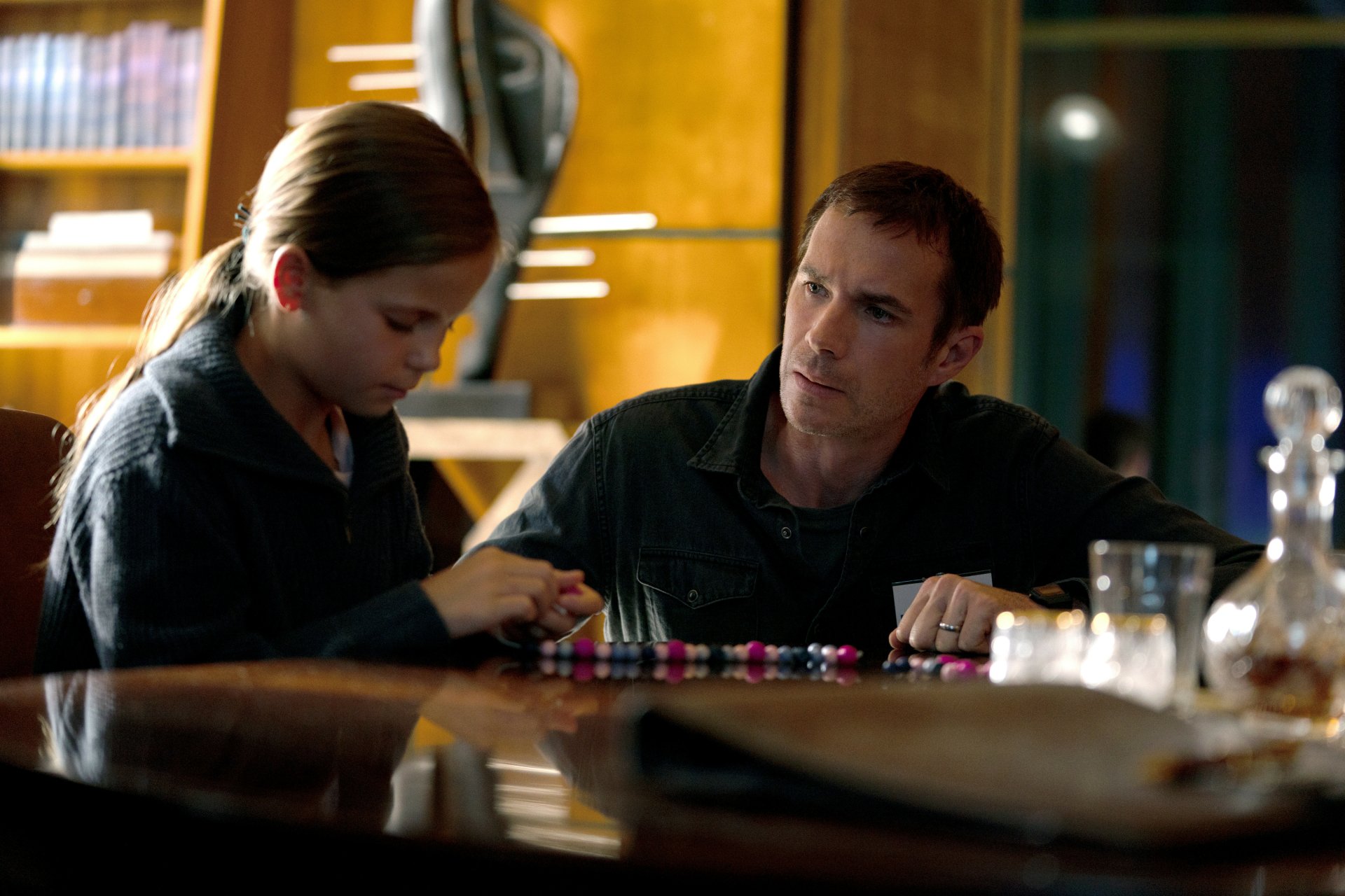 HD wallpaper featuring a scene from the 2024 TV show Constellation with two characters engaged in an intense conversation over a table with poker chips.