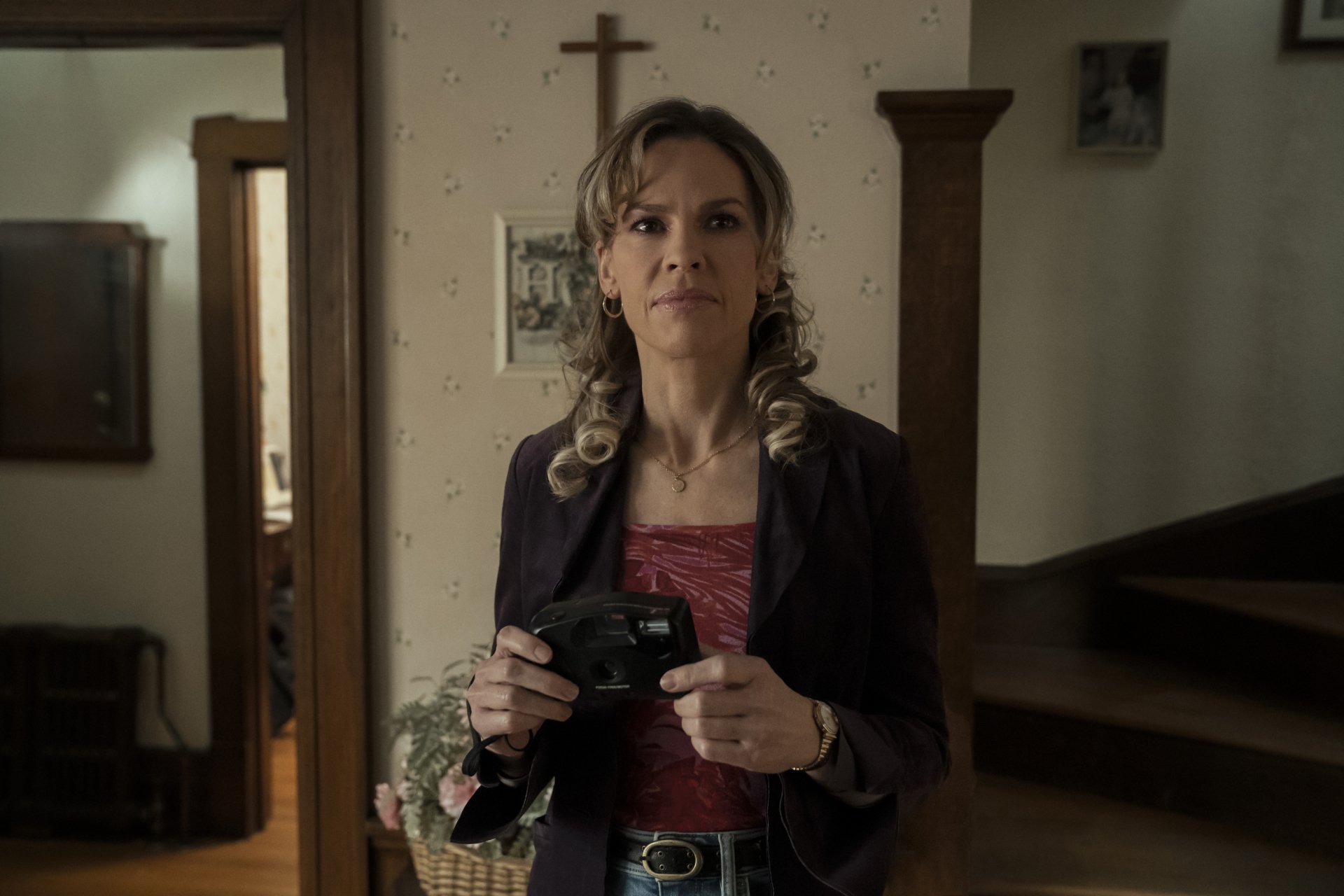 Hilary Swank in a scene from the movie Ordinary Angels, looking contemplative, available as HD desktop wallpaper and background.