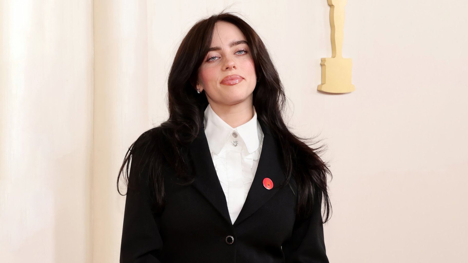 Billie Eilish in a stylish black outfit posing at the Academy Awards event - HD desktop wallpaper and background.