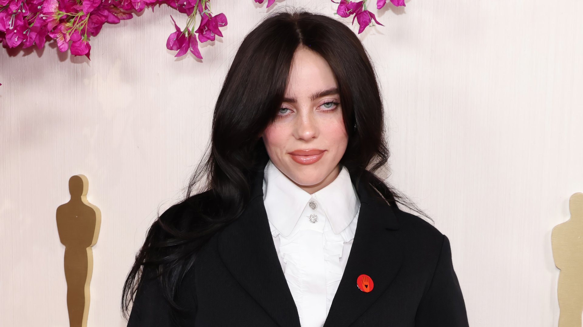 Billie Eilish at the Academy Awards, posing for a stylish HD desktop wallpaper background with Oscars theme.