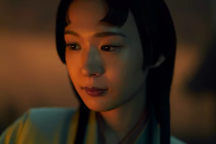 HD wallpaper of Shogun 2024 TV show featuring a close-up of a female character with a contemplative expression, set against a warm, dimly lit background.