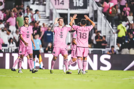 Inter Miami CF soccer players in pink kits celebrating on the pitch, for use as an HD desktop wallpaper and background.