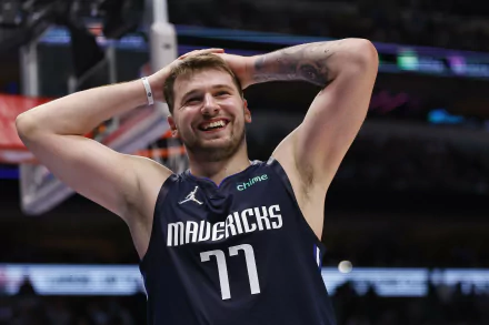 HD wallpaper featuring a Dallas Mavericks basketball player on the court wearing a jersey with the number 77, expressing a moment of emotion during a game.