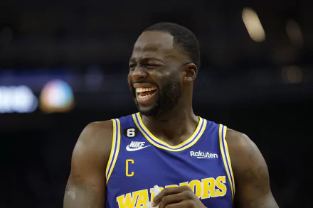 Draymond Green of the Golden State Warriors shares a joyful moment during a game, captured in this vibrant HD wallpaper that showcases his dynamic energy and spirit.