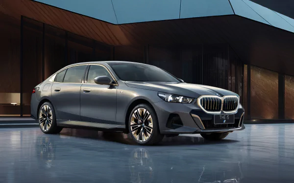Sleek BMW i5 M Sport car in grey, showcased as HD desktop wallpaper and background, highlighting its luxurious design and advanced vehicle features.