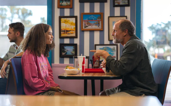 HD wallpaper from Suncoast (2024) featuring two characters in conversation at a diner.