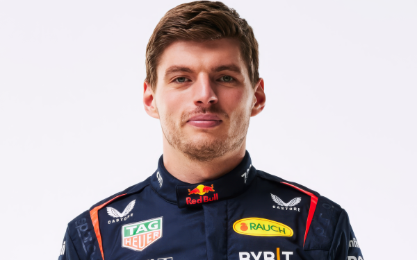 HD Wallpaper of a smiling F1 driver in Red Bull racing suit for sports desktop background.