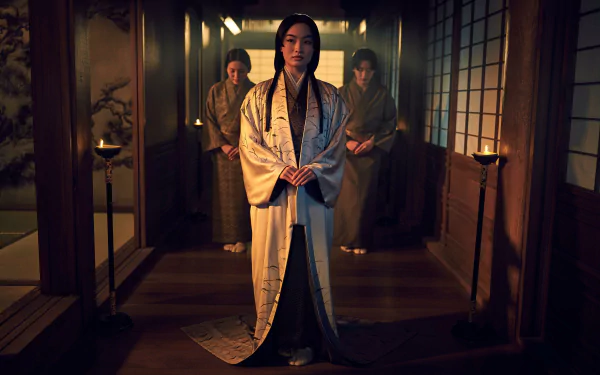 HD wallpaper featuring a scene from the 2024 TV show Shogun with a central character in traditional Japanese attire standing in a dimly lit room with other characters in the background.