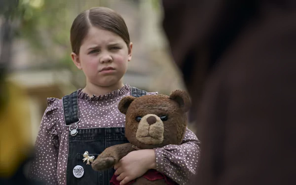 Young girl with a stern expression holding a teddy bear from the movie Imaginary (2024), HD desktop wallpaper.