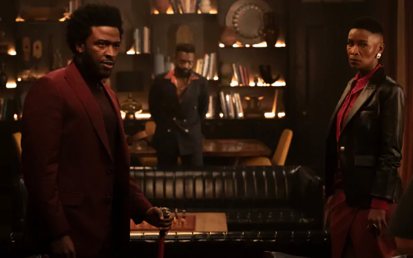 HD wallpaper of two characters from the 2024 TV show Parish standing in a dimly lit room with vintage decor.