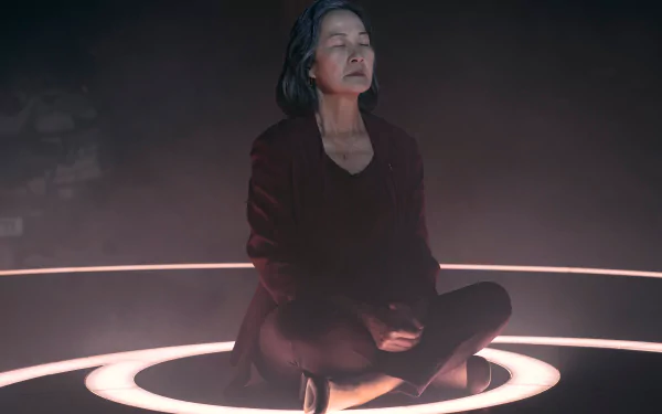 Scene from The Three-Body Problem TV show featuring a character meditating inside a ring of light, available as HD desktop wallpaper and background.