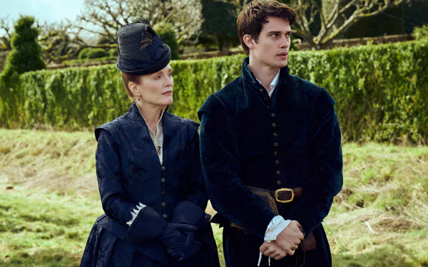 Julianne Moore and Nicholas Galitzine star in Mary & George, captured in a striking HD wallpaper, showcasing their character's historical attire against a scenic backdrop.