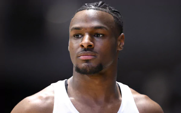 Bronny James poses confidently in this HD desktop wallpaper, showcasing his athleticism and focus. A striking background for fans and basketball enthusiasts alike.