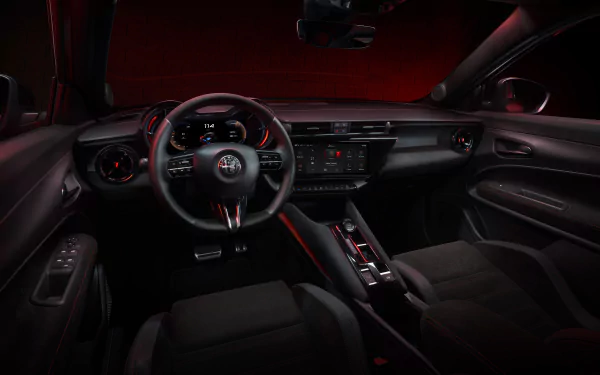 Interior view of an Alfa Romeo Milano Veloce showcasing the steering wheel and dashboard with red ambient lighting, intended as an HD desktop wallpaper and background.