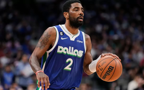 HD desktop wallpaper featuring a Dallas Mavericks basketball player dribbling a ball during a game, wearing a jersey with the number 2.