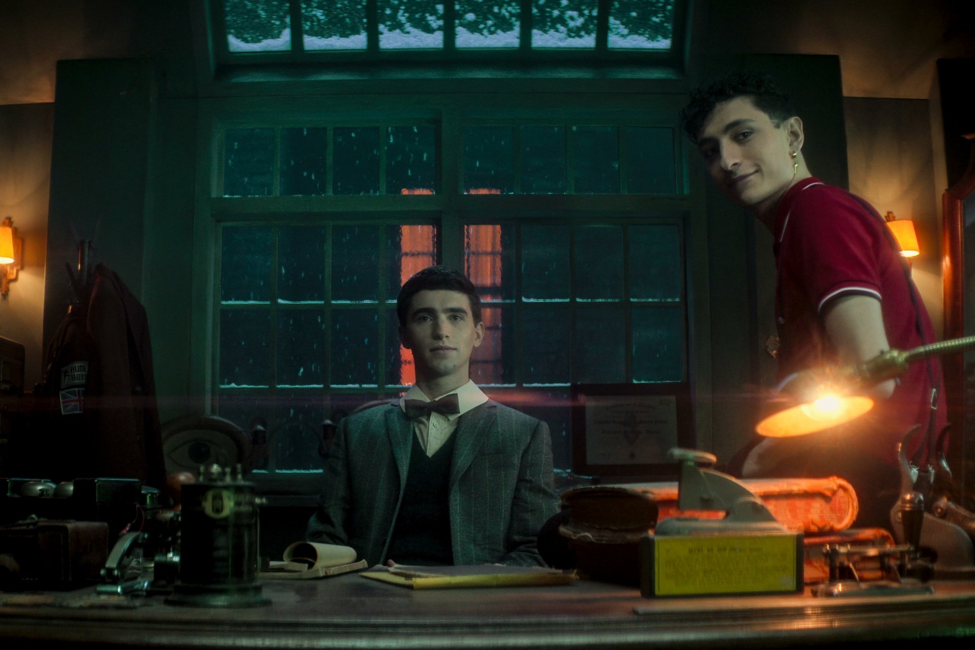 HD desktop wallpaper featuring two young male characters from the TV show Dead Boy Detectives in a dimly lit, vintage-style office.