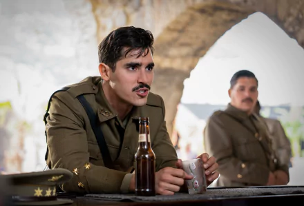 HD desktop wallpaper from The Ministry of Ungentlemanly Warfare featuring a scene with two military officers, one in focus holding a bottle.