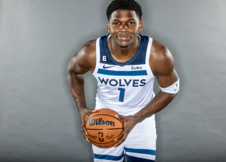 HD desktop wallpaper featuring Anthony Edwards, a Minnesota Timberwolves player, dressed in his team's uniform holding a basketball.