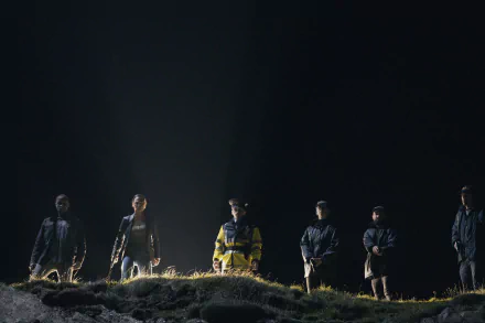 HD desktop wallpaper from the TV show Bodkin featuring a group of characters illuminated by a solitary light in a dark setting.