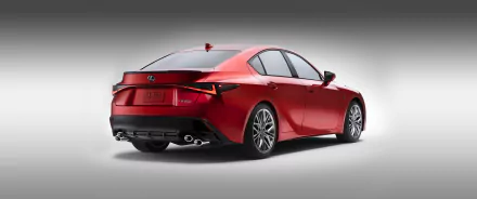 HD desktop wallpaper featuring a sleek, red Lexus IS 500 F Sport Performance car, viewed from the rear, showcasing its stylish design and modern lines.