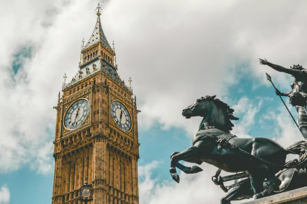 HD desktop wallpaper featuring Big Ben in London, England, with a dramatic statue in the foreground against a cloudy sky backdrop.