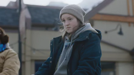 A detailed 8K Ultra HD PC desktop wallpaper featuring a young person in a beanie and jacket, captured in a contemplative moment from The Last of Us.