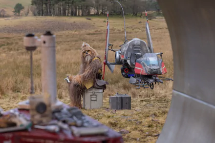 HD desktop wallpaper from the TV show The Acolyte (2024), featuring Chewbacca sitting in a field beside a futuristic vehicle.
