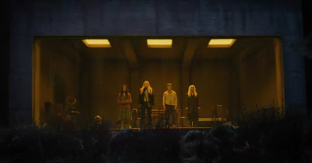 HD desktop wallpaper and background featuring a still from the movie The Watchers (2024) with four people standing in a dimly lit room viewed through a wide window.