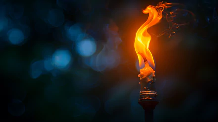Close-up HD image of a torch with a vibrant flame against a dark, blurred background.