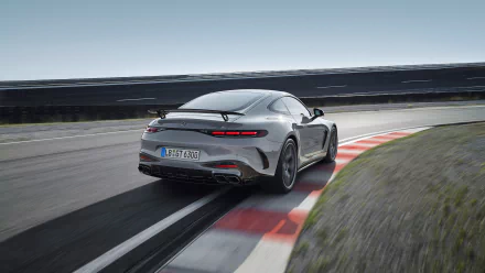 HD desktop wallpaper featuring a Mercedes-AMG GT63 PRO, showcasing its sleek design as it navigates a racetrack curve under a clear sky.