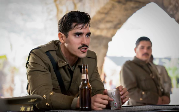 HD desktop wallpaper from The Ministry of Ungentlemanly Warfare featuring a scene with two military officers, one in focus holding a bottle.