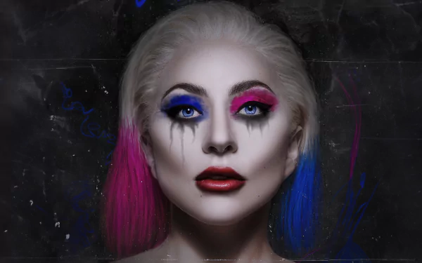HD desktop wallpaper featuring Lady Gaga with dramatic Joker-inspired makeup, vibrant blue and pink hair for Joker: Folie à Deux.