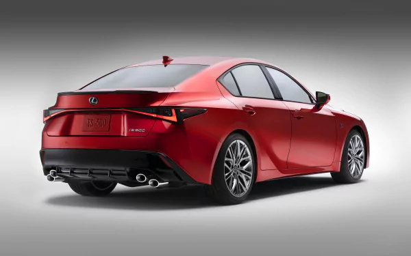 HD desktop wallpaper featuring a sleek, red Lexus IS 500 F Sport Performance car, viewed from the rear, showcasing its stylish design and modern lines.