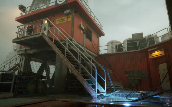 High-definition desktop wallpaper from the video game Still Wakes the Deep, featuring an industrial exterior with metal stairs leading to an upper platform, surrounded by various machinery under an overcast sky.