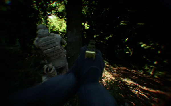 HD desktop wallpaper featuring a first-person view from a video game, resembling a bodycam perspective in a dense forest setting, with a gloved hand holding a firearm and a soldier in tactical gear ahead.