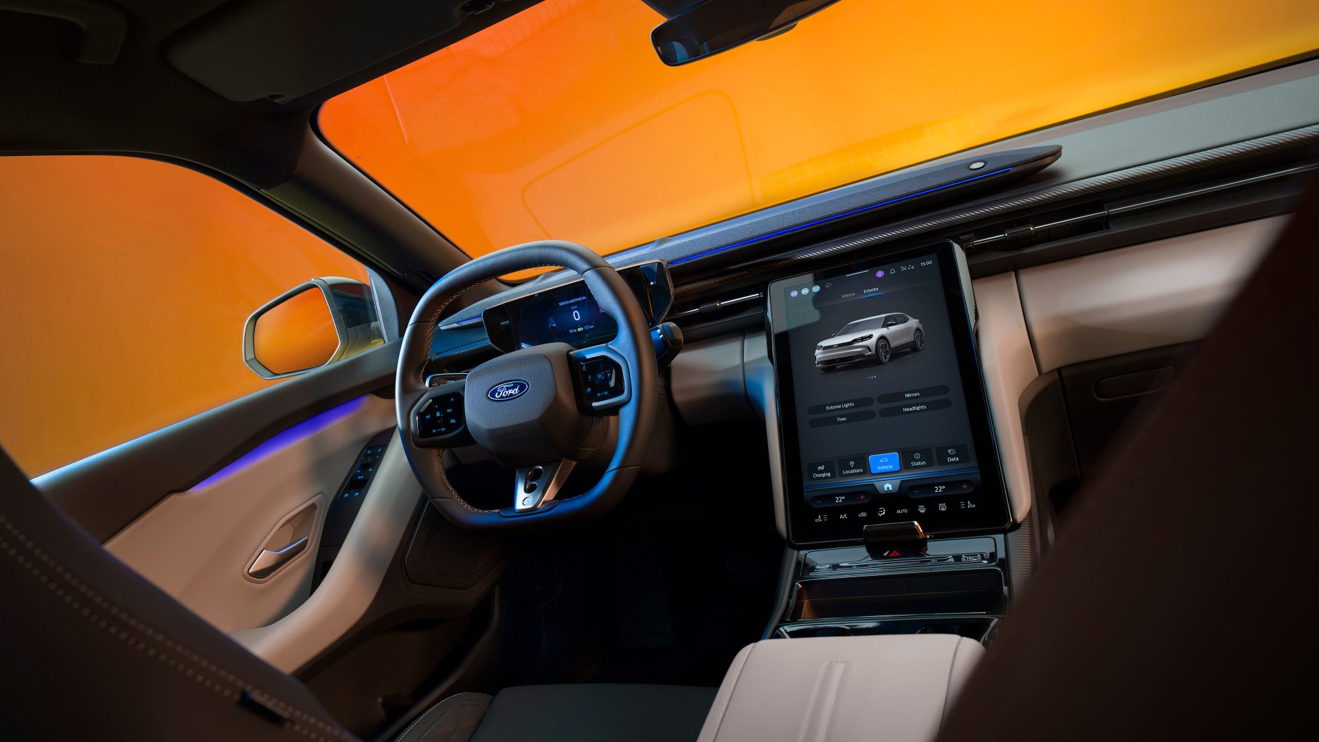 Interior view of a Ford Capri, showcasing its modern dashboard and touchscreen display against a vibrant orange background. This image serves as a stunning 4K Ultra HD wallpaper.