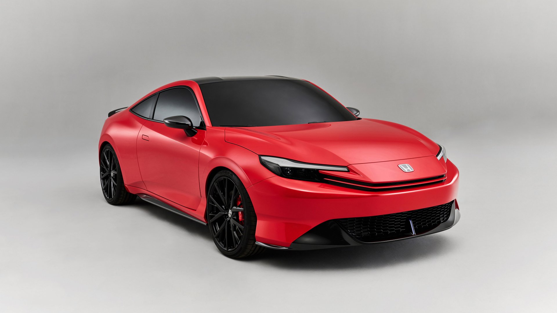 A striking red Honda Prelude showcased as a high-definition desktop wallpaper, featuring a sleek design and modern aesthetic against a neutral background.
