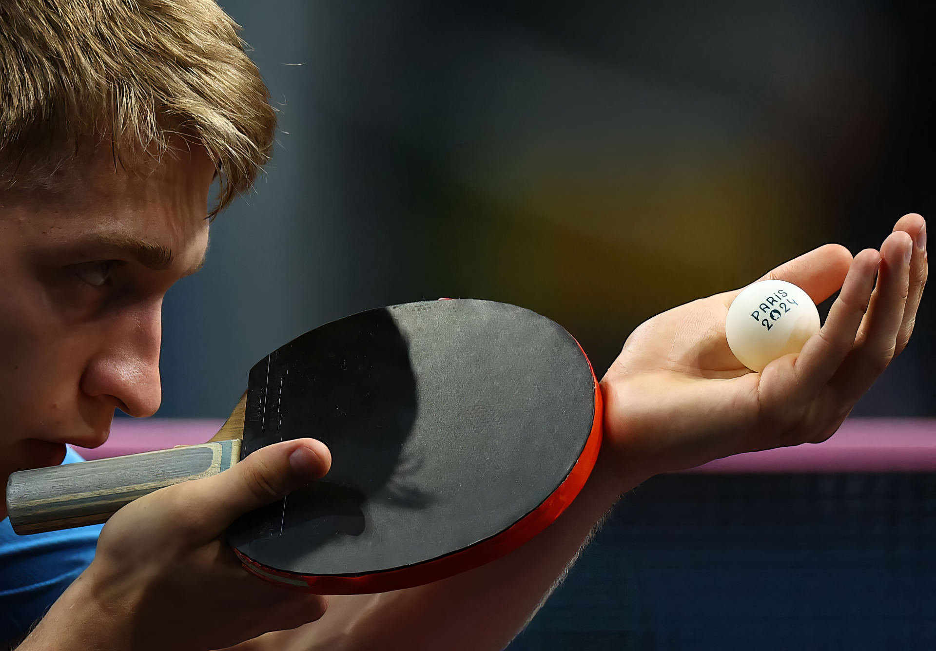 A focused table tennis player from Sweden prepares for a serve, showcasing the intensity of the sport ahead of the Olympic Games Paris 2024 in this HD desktop wallpaper.