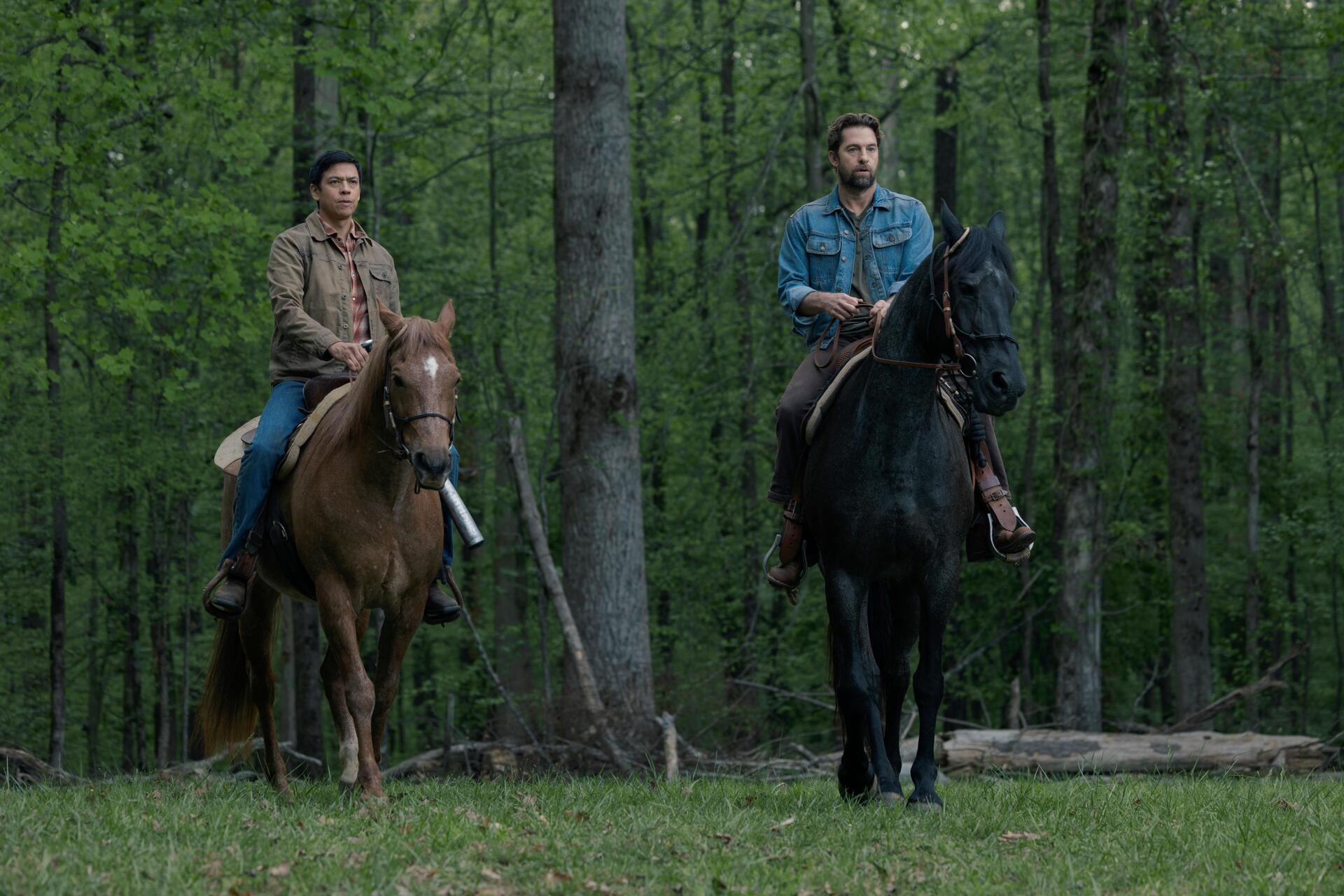 A scene from the TV show Teacup (2024), featuring Scott Speedman and another character, both on horseback in a lush green forest setting. 8K Ultra HD quality.