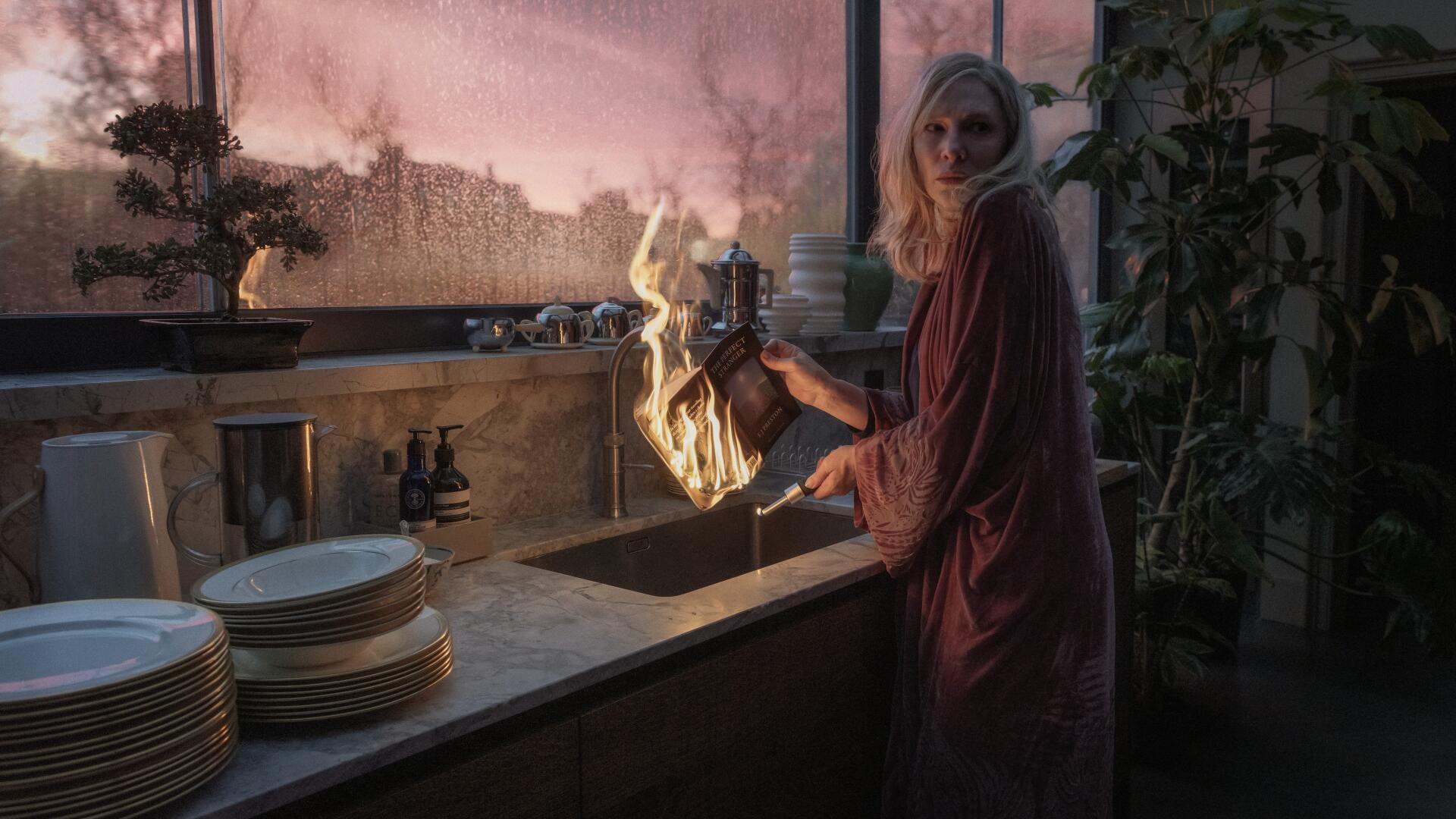 Cate Blanchett in a dramatic scene from the TV show Disclaimer (2024), showcasing a kitchen setting with a striking visual of flames in a 4K Ultra HD desktop wallpaper.