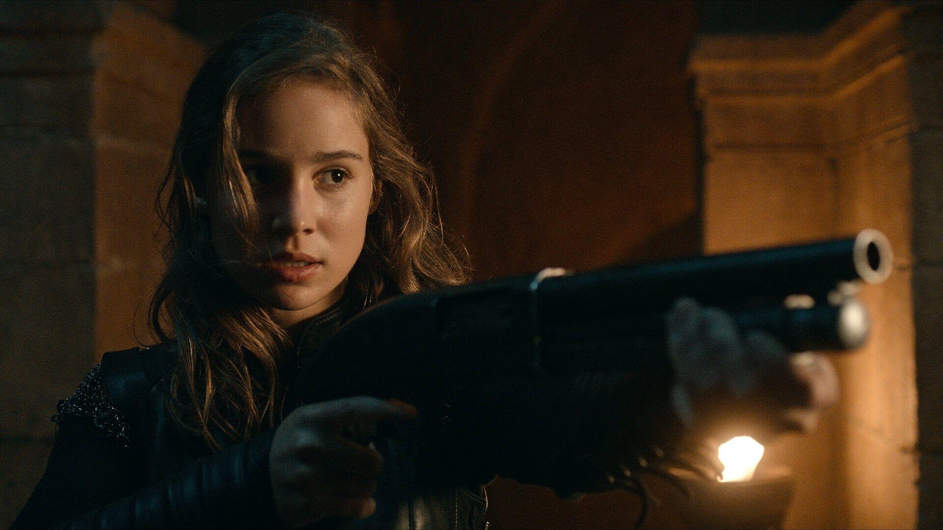 A dramatic scene from the TV show Warrior Nun, featuring Alba Baptista aimed to convey intensity and determination, captured in a high-definition desktop wallpaper.