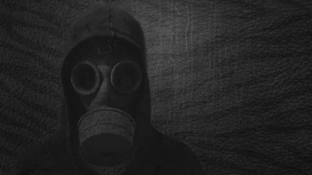 HD PC desktop wallpaper featuring a grey-toned image of a person wearing a military-style gas mask and hood against a textured background.