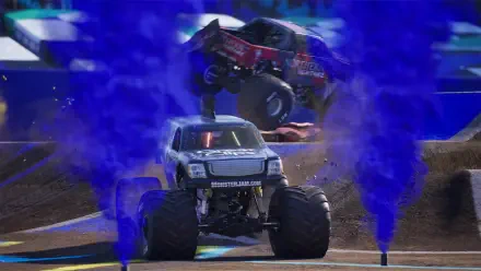 High-definition desktop wallpaper featuring intense action from the Monster Jam Showdown, showcasing a monster truck performing a stunt with blue smoke effects in the background.