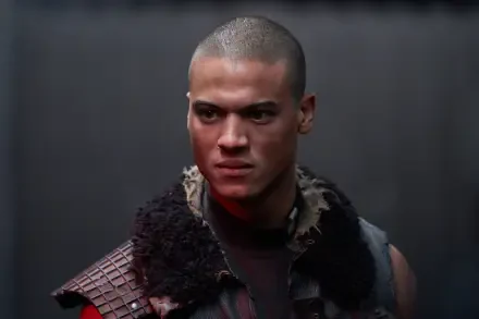 A close-up of a character from the movie Uglies, featuring a determined expression and a textured outfit, set against a dark background. 4K Ultra HD desktop wallpaper.