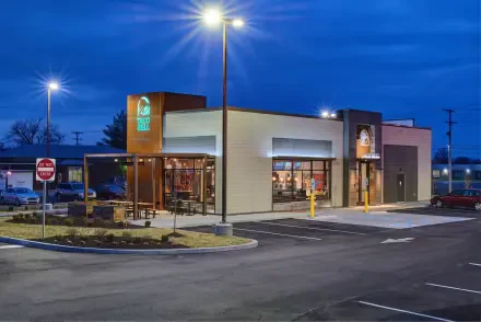 A man-made Taco Bell restaurant illuminated at dusk, captured in 4K Ultra HD as a detailed PC desktop wallpaper and background.