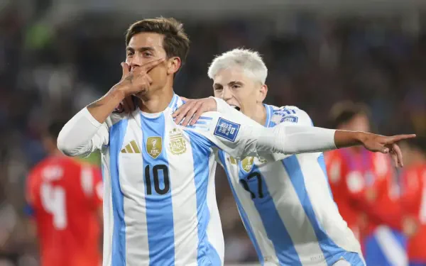 HD PC desktop wallpaper capturing an Argentine soccer player celebrating a goal during an intense match.