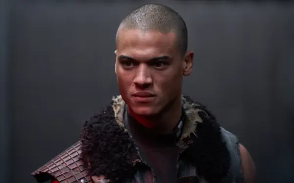 A close-up of a character from the movie Uglies, featuring a determined expression and a textured outfit, set against a dark background. 4K Ultra HD desktop wallpaper.